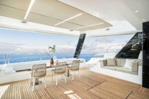 2026 Sunreef 70 Sunreef Power catamaran main salon with modern furnishings and large windows overlooking the water.