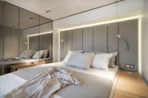 2026 Sunreef 70 Sunreef Power catamaran salon with neutral upholstery, panoramic windows, and integrated helm station visi...