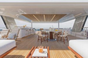 2026 Sunreef 80 Sunreef Power catamaran main salon with neutral upholstered seating, large windows, and modern interior fi...