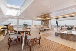 2026 Sunreef 80 Sunreef Power catamaran salon with contemporary furnishings and large windows overlooking the water.