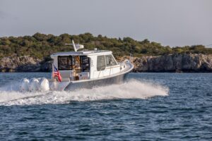 True North 39 Outboard Express helm station with dual Garmin displays, center console steering, and forward visibility thr...