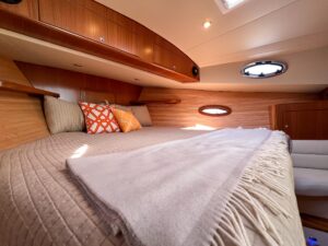 Helm station of 2026 True North 39 Outboard Express with center console steering, dual Garmin displays, and forward visibi...