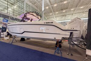 Wellcraft 38 T-Top center console with full hardtop and bow seating viewed from starboard angle.