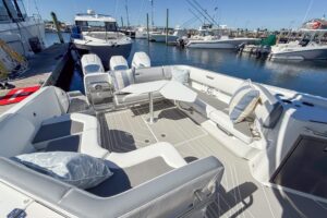 Wellcraft 38 T-Top center console helm station with dual Garmin displays and stainless steel wheel.